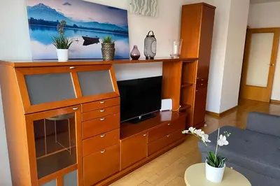 a living room with a entertainment center with a flat screen tv at NEW! Amazing 2 bedroom apartment in Rambla del Poblenou in Barcelona