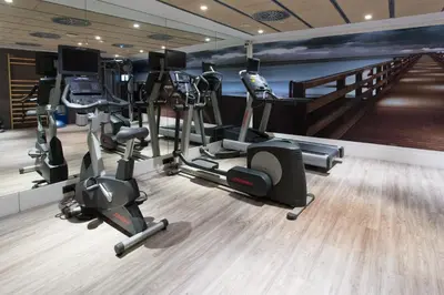 a gym with treadmills and cardio equipment in a room at Catalonia Avinyo in Barcelona