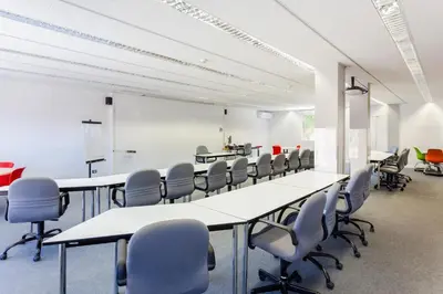 a conference room with white tables and chairs at Checkin Montserrat in Collbató