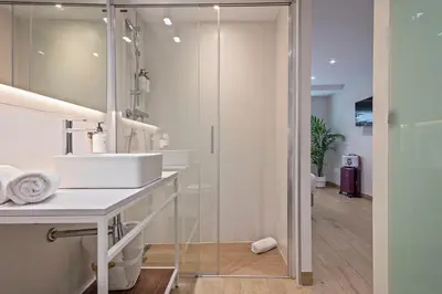 a bathroom with a sink and a mirror at Aparthotel Bcn Montjuic in Barcelona
