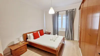 a bedroom with a bed with red pillows and a window at Barcelona4Seasons - Sagrada Familia in Barcelona