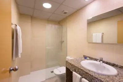 a bathroom with a sink and a toilet and a shower at SG Costa BCN Apartments in Castelldefels