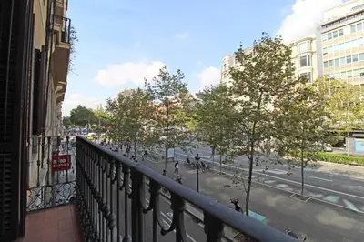 a view from a balcony of a street with trees at Paseo de gracia gran vía de les corts catalanes in Barcelona
