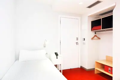 a bedroom with a white bed and a red floor at Ciutat Vella in Barcelona