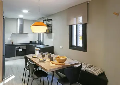 a kitchen with a table and chairs in a room at Fridays Flats Onix House in Hospitalet de Llobregat