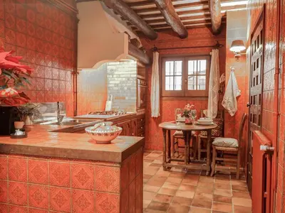 a kitchen with red walls and a table in it at Beach Villa Aralinn by Hello Homes Sitges in Sitges