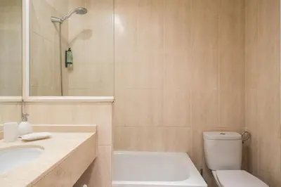 a bathroom with a toilet and a sink and a shower at Cozy Apt with charm and exquisite natural light in Barcelona