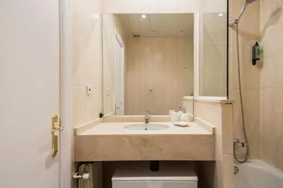 a bathroom with a sink and a toilet at Cozy Apt with charm and exquisite natural light in Barcelona