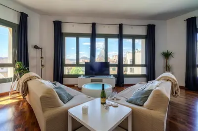 a living room with two couches and a tv at Espectacular loft en centrico edificio singular in Manresa