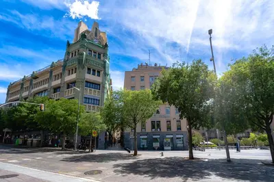 a tall building on a city street with trees at Espectacular loft en centrico edificio singular in Manresa