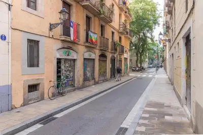 an empty street in a city with buildings at Barnapartments Raval in Barcelona