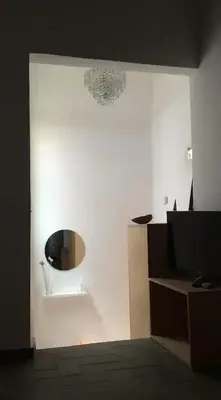 a room with a white wall with a mirror at CAM Maresme 2 Apartamento Barcelona y playa in Masnou