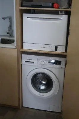 a washing machine with a tv on top of it at CAM Maresme 2 Apartamento Barcelona y playa in Masnou