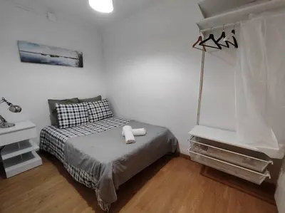 a bedroom with a bed with two white towels on it at Barcelona estadio nuevo in Hospitalet de Llobregat