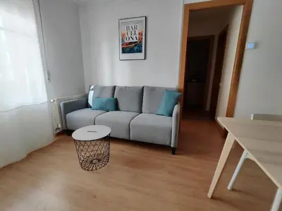 a living room with a couch and a table at Barcelona estadio nuevo in Hospitalet de Llobregat