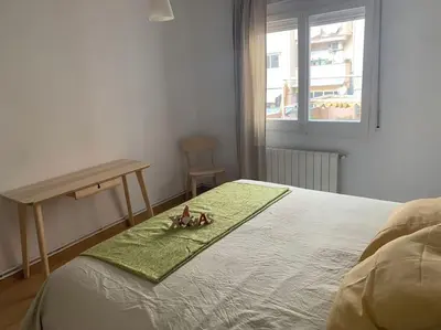 a bedroom with a bed with two dolls sitting on it at Barcelona estadio nuevo in Hospitalet de Llobregat