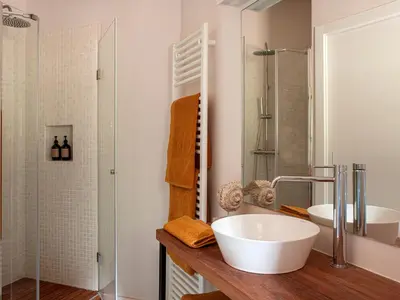 a bathroom with two sinks and a shower at Les Canes 2 in Aiguafreda