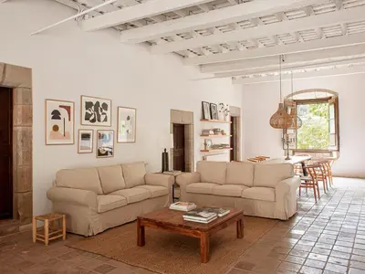 a living room with two couches and a table at Les Canes 2 in Aiguafreda