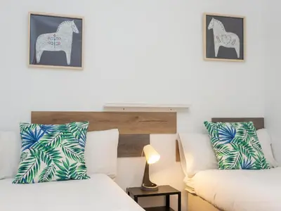 a hotel room with two beds and an elephant pillow at Click&Flat Fira Castelao in Hospitalet de Llobregat