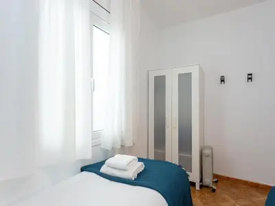 a bedroom with a bed with towels on it at Click&Flat Fira Castelao in Hospitalet de Llobregat