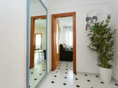 a hallway with a mirror and a potted plant at Click&Flat Fira Castelao in Hospitalet de Llobregat