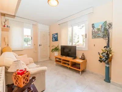 a living room with a couch and a tv at Holiday Home Aurea by Interhome in Pineda de Mar