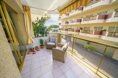 an apartment balcony with a view of the courtyard at HomeHolidaysRentals Liberty - Costa Barcelona in Pineda de Mar