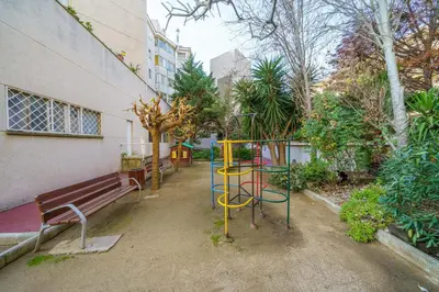 a park with a bench and a playground at HomeHolidaysRentals Liberty - Costa Barcelona in Pineda de Mar