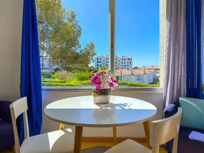 a living room with a couch and a table at The Blue Island Loft by Hello Homes Sitges in Sitges
