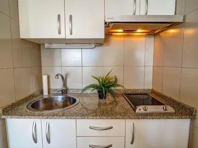 a kitchen counter top with a sink and a sink at The Blue Island Loft by Hello Homes Sitges in Sitges