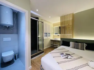 a living room with a tv on a wall at The Collection Barcelona - Plaza Catalunya Recently renovated 5BD-4BTH in Barcelona