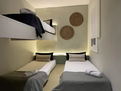 two beds sitting in a room withermottermottermott at The Collection Barcelona - Plaza Catalunya Recently renovated 5BD-4BTH in Barcelona