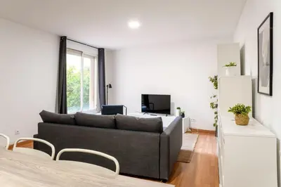 a living room with a couch and a television at The Collection Barcelona - Plaza Urquinaona Central and comfortable 3BD in Barcelona