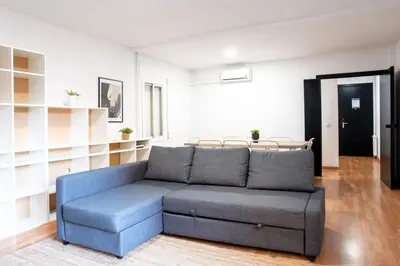 a living room with a blue couch in a room at The Collection Barcelona - Plaza Urquinaona Central and comfortable 3BD in Barcelona