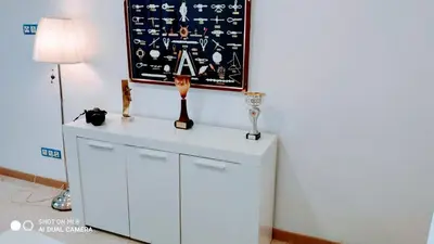 a white cabinet in a room with a painting on the wall at Hostal Estudios in Badalona