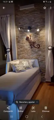 a bedroom with a bed and a brick wall at Villa Alba cerca de Sitges in Canyelles