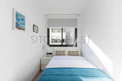 a white bedroom with a bed and a window at Sitges PORT - Con piscina, a 5 minutos de la playa in Sitges