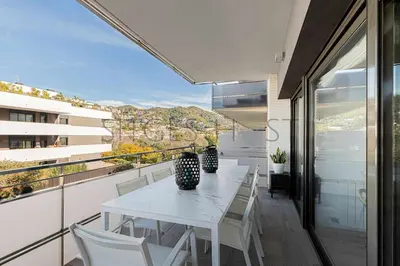 a white table and chairs on a balcony with a view at Sitges PORT - Con piscina, a 5 minutos de la playa in Sitges