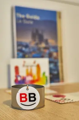 a small metal object with the letter b on a table at BBarcelona Clot Apartments in Barcelona