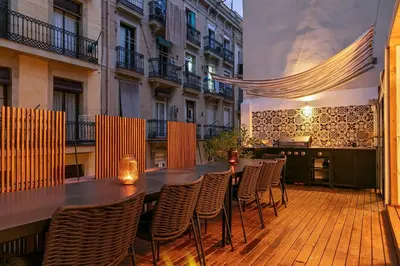 a patio with a table and chairs on a balcony at Penthouse with Rooftop apartment in the Barceloneta - Barcelona in Barcelona