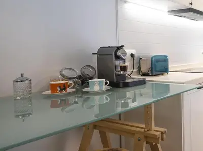 a counter with cups and a coffee maker on it at BCN: ¡Exclusivos y cerca del Camp Nou! in El Arrabal