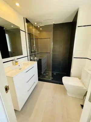 a bathroom with a sink and a toilet and a shower at La Marina2 SeaView with amazing terrace in Sitges