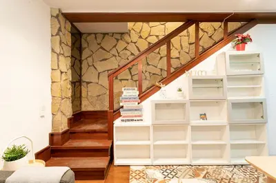a staircase with white shelves in a room at Barcelona Beach Home in Barcelona