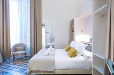 a hotel room with a bed with yellow pillows at Feelathome Casa Bertrand in Barcelona