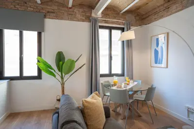 a living room with a couch and a table at Feelathome Stadium Apartments in Hospitalet de Llobregat