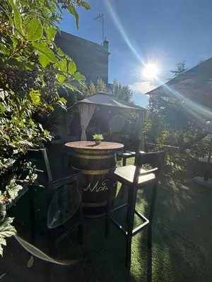 a table and two chairs and a table and a grill at Spirit of Queen experience in Barcelona