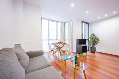 a living room with a couch and a table at Sweett - Eixample Central in Barcelona