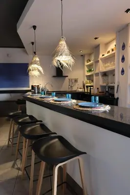 a kitchen counter with green glasses on a shelf at El Cedre Blau Vivienda con piscina en Granollers in Granollers