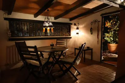 a dining room with a wooden table and chairs at El Cedre Blau Vivienda con piscina en Granollers in Granollers