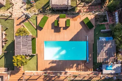 a house with a swimming pool in front of a house at \u30c4 Villa Carrasca l Luxe l Vista al Mar l Piscina Climatizada l Nature in Arenys de Munt